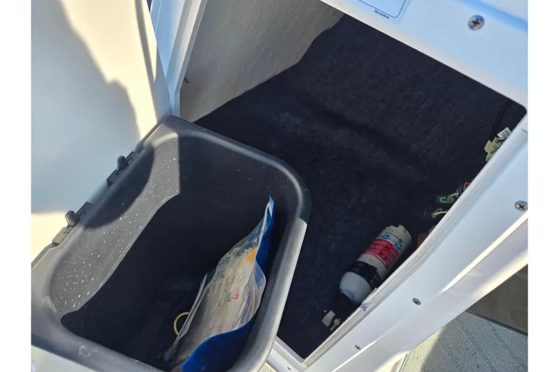 Slide: The Image of Storage compartment in 2020 Yamaha SX190 boat with fire extinguisher and container. - 16