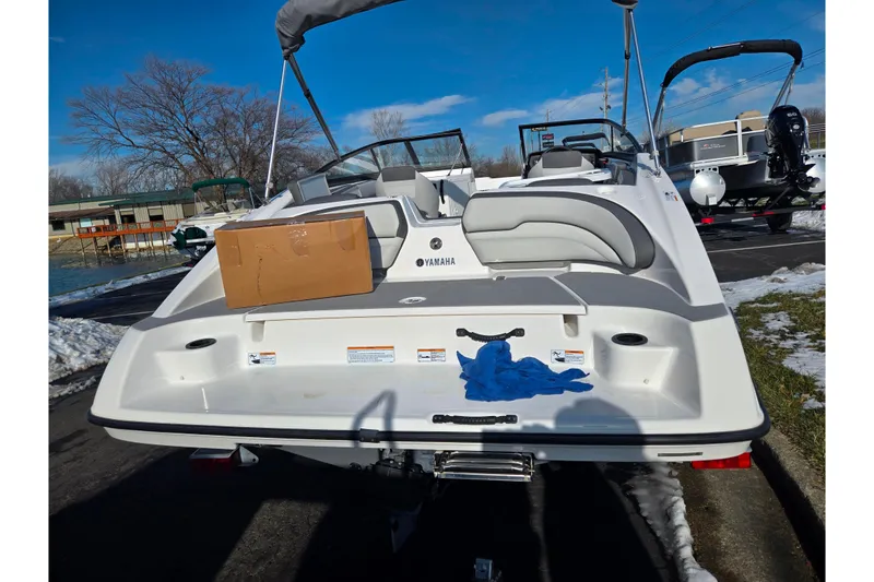 Slide: The Image of 2020 Yamaha Boats SX190, rear view, parked outdoors with snow and blue sky. - 2