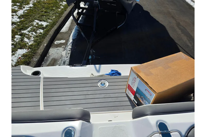Slide: The Image of 2020 Yamaha Boats SX190 with box on deck, parked on snowy pavement. - 23