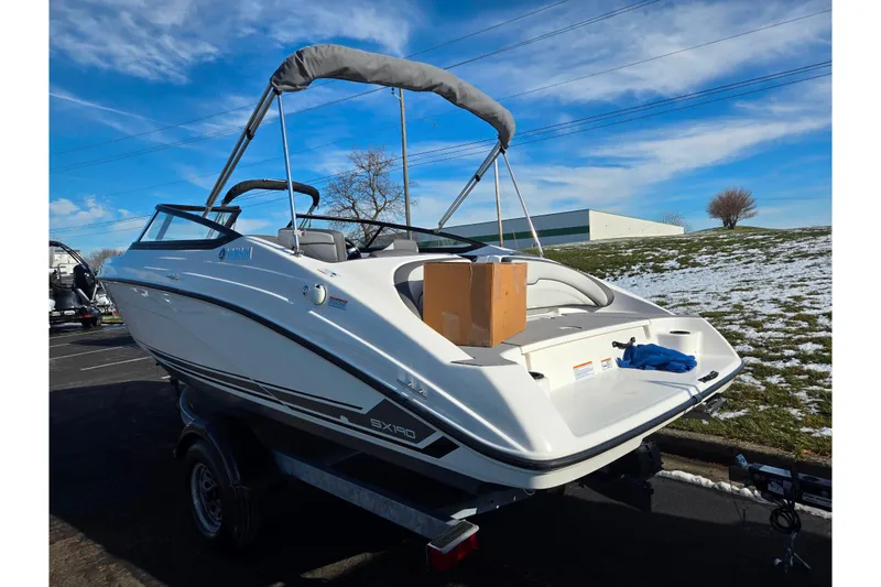 Slide: The Image of 2020 Yamaha Boats SX190 on trailer, parked outdoors with snowy landscape. - 3