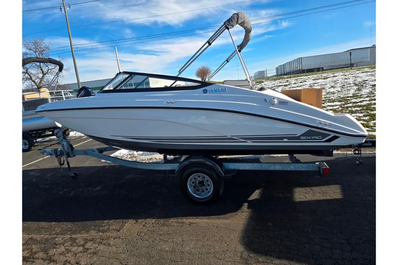 Slide: The Image of 2020 Yamaha Boats SX190 on trailer, parked outdoors under clear blue sky. - 4