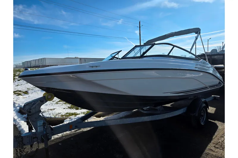 Slide: The Image of 2020 Yamaha Boats SX190 on trailer, parked outdoors under clear blue sky. - 5