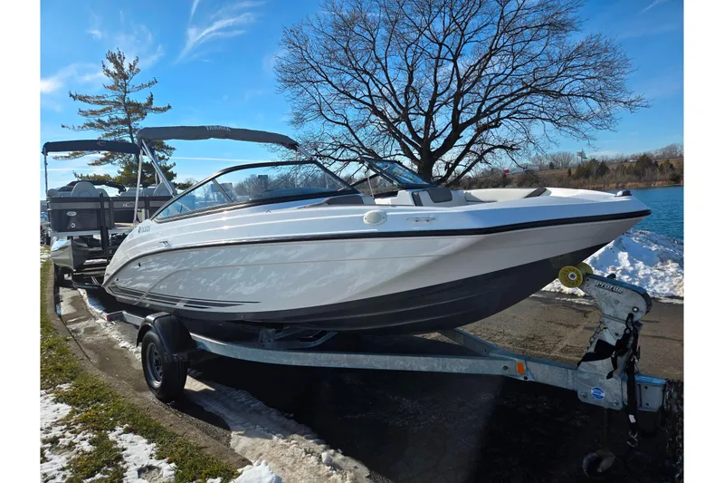 Slide: The Image of 2020 Yamaha Boats SX190 on trailer by a snowy lakeside. - 8