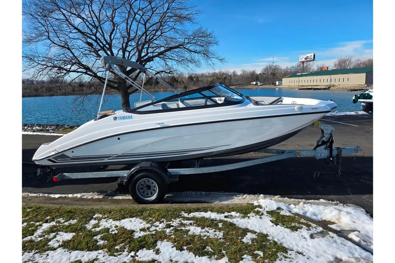 Slide: The Image of 2020 Yamaha Boats SX190 on trailer by a lake, winter setting. - 9