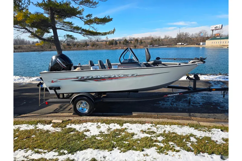 Slide: The Image of 2021 Tracker Pro Guide V-165 WT boat on trailer by a lake in winter. - 10