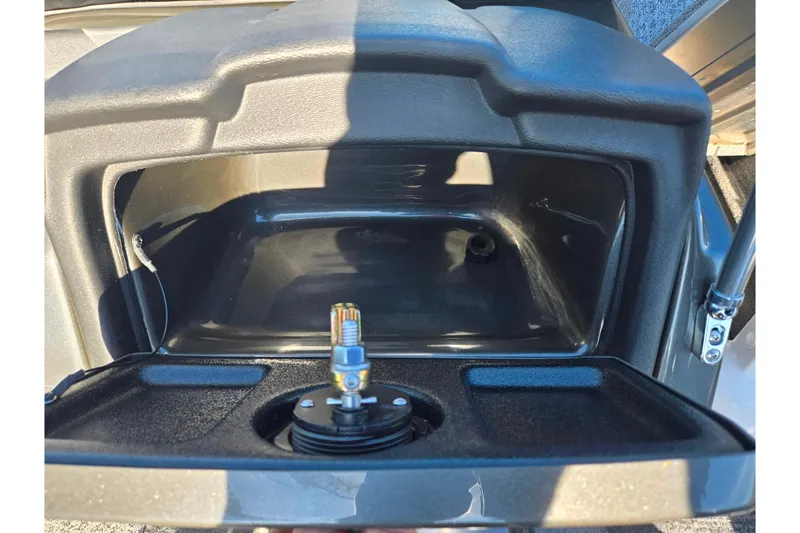 Slide: The Image of 2021 Tracker Pro Guide V-165 WT storage compartment with open lid and visible wiring. - 14
