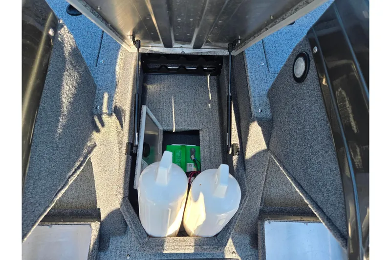 Slide: The Image of 2021 Tracker Pro Guide V-165 WT boat storage compartment with containers and supplies. - 17