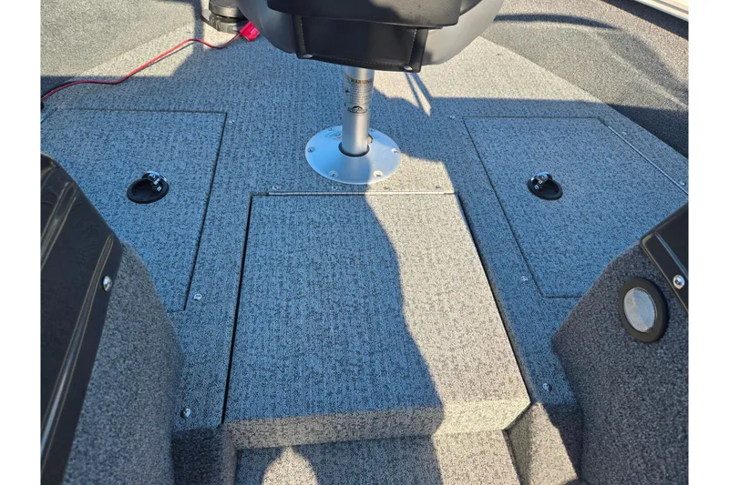 Slide: The Image of 2021 Tracker Pro Guide V-165 WT boat interior with carpeted flooring and seating. - 18