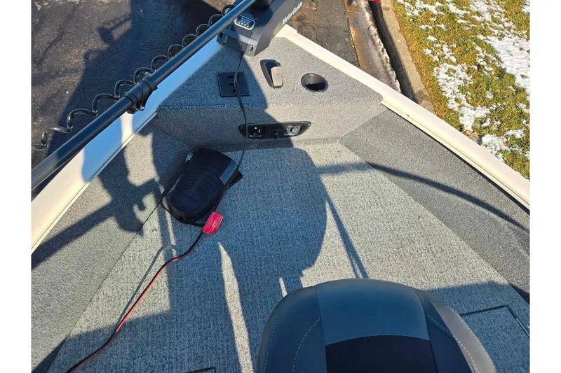 Slide: The Image of 2021 Tracker Pro Guide V-165 WT boat interior with fishing equipment and seating. - 21