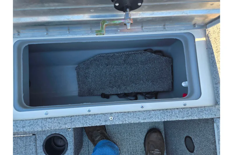 Slide: The Image of 2021 Tracker Pro Guide V-165 WT boat storage compartment with carpeted interior and cup holder. - 29