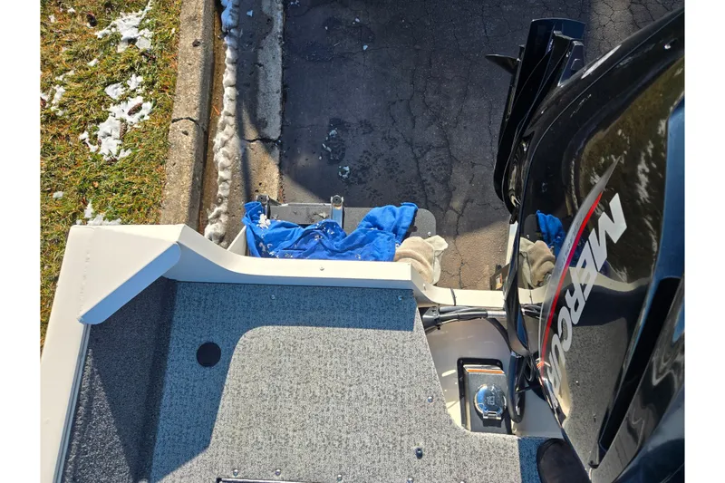 Slide: The Image of 2021 Tracker Pro Guide V-165 WT boat with Mercury engine, parked on pavement. - 31