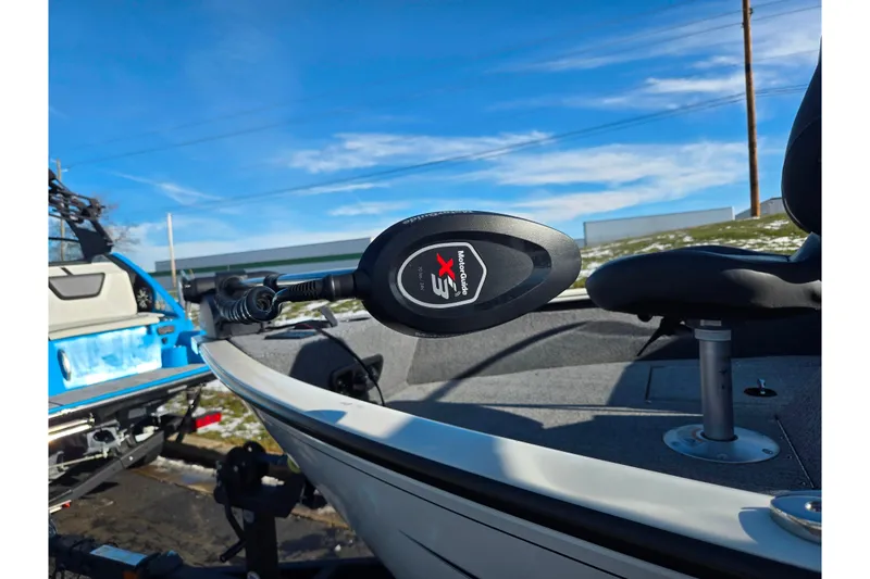 Slide: The Image of 2021 Tracker Pro Guide V-165 WT boat with MotorGuide trolling motor, parked outdoors. - 5