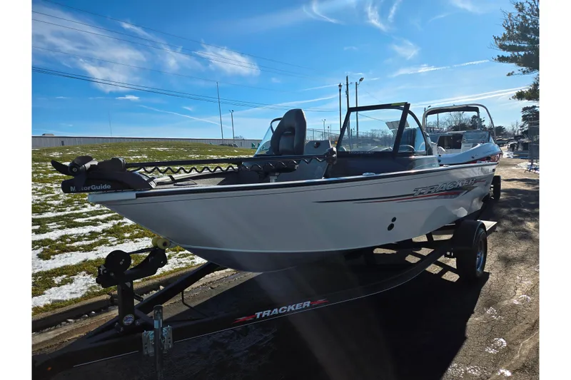 Slide: The Image of 2021 Tracker Pro Guide V-165 WT boat on trailer under clear blue sky. - 6