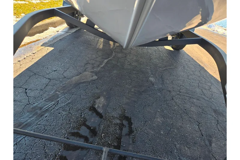 Slide: The Image of 2021 Tracker Pro Guide V-165 WT boat on trailer, parked on cracked pavement. - 8