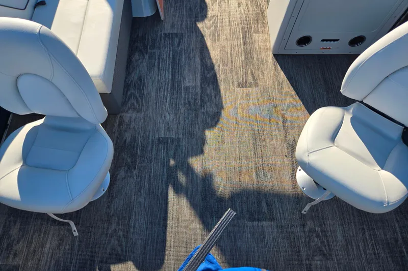 Slide: The Image of Interior of 2022 Crest Classic Fish 200 boat with white seats and wood flooring. - 10
