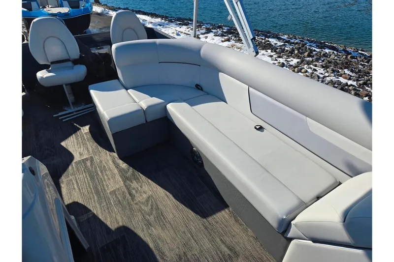 Slide: The Image of 2022 Crest Classic Fish 200 boat interior with gray seating and wood-style flooring. - 15