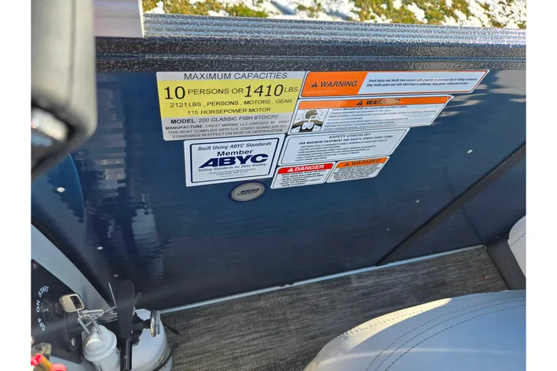 Slide: The Image of 2022 Crest Classic Fish 200 capacity and safety warning labels on boat interior. - 17