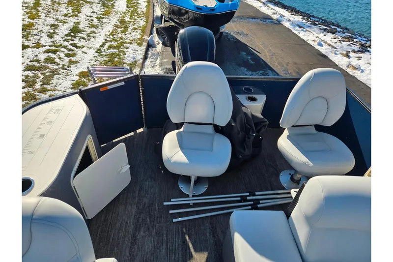 Slide: The Image of 2022 Crest Classic Fish 200 boat interior with white seats and fishing rods. - 18