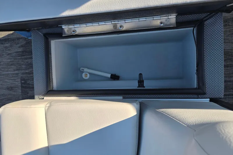Slide: The Image of Open storage compartment in 2022 Crest Classic Fish 200 boat, showing interior details. - 19