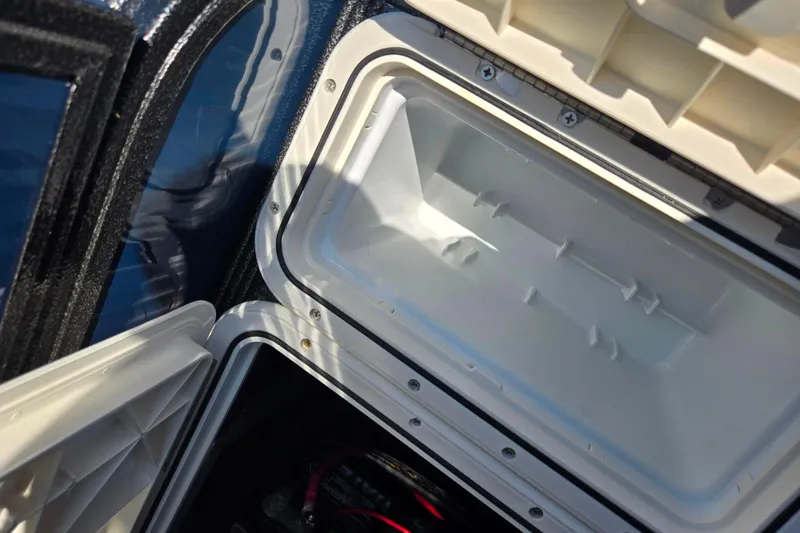 Slide: The Image of Open storage compartment in 2022 Crest Classic Fish 200 boat. - 22