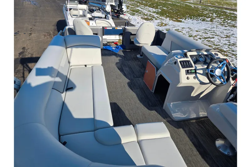 Slide: The Image of 2022 Crest Classic Fish 200 pontoon boat interior with spacious seating and modern dashboard. - 23