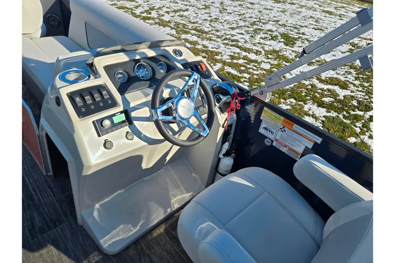 Slide: The Image of 2022 Crest Classic Fish 200 boat dashboard with steering wheel and controls. - 24