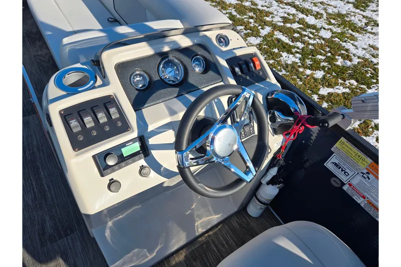Slide: The Image of 2022 Crest Classic Fish 200 boat dashboard with steering wheel and control panel. - 25
