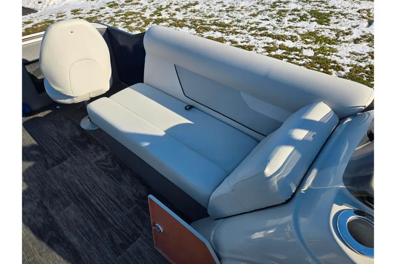 Slide: The Image of 2022 Crest Classic Fish 200 boat interior with white seating and snowy background. - 26