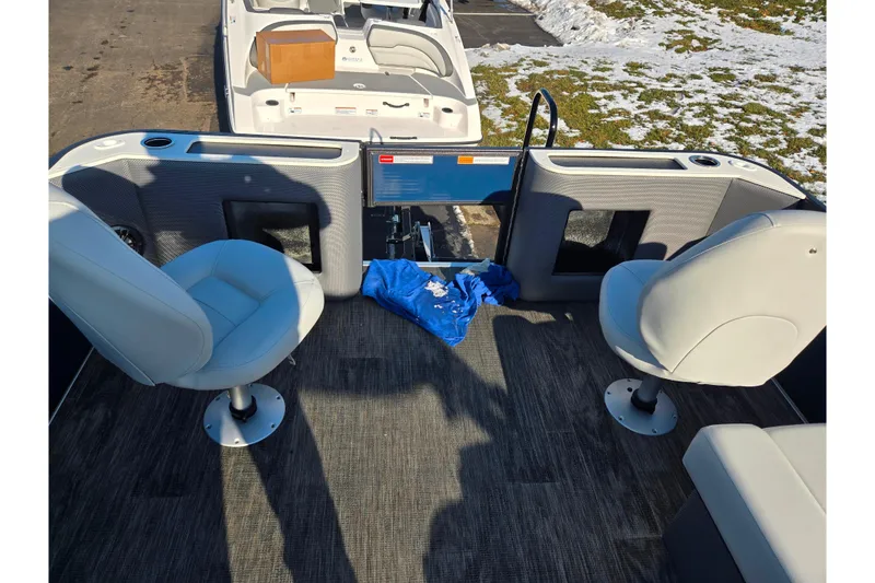 Slide: The Image of 2022 Crest Classic Fish 200 boat interior with two swivel seats and carpeted floor. - 27