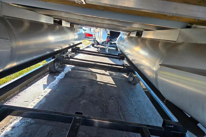 Slide: The Image of Underneath view of a 2022 Crest Classic Fish 200 pontoon boat on a trailer. - 7