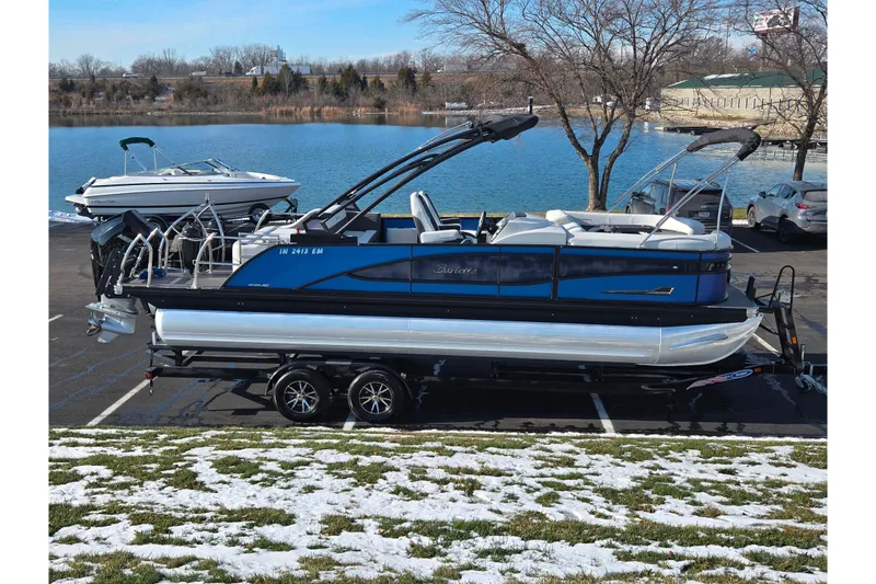 The Image of 2023 Barletta Corsa 23UC pontoon boat parked by a scenic lake. - 0