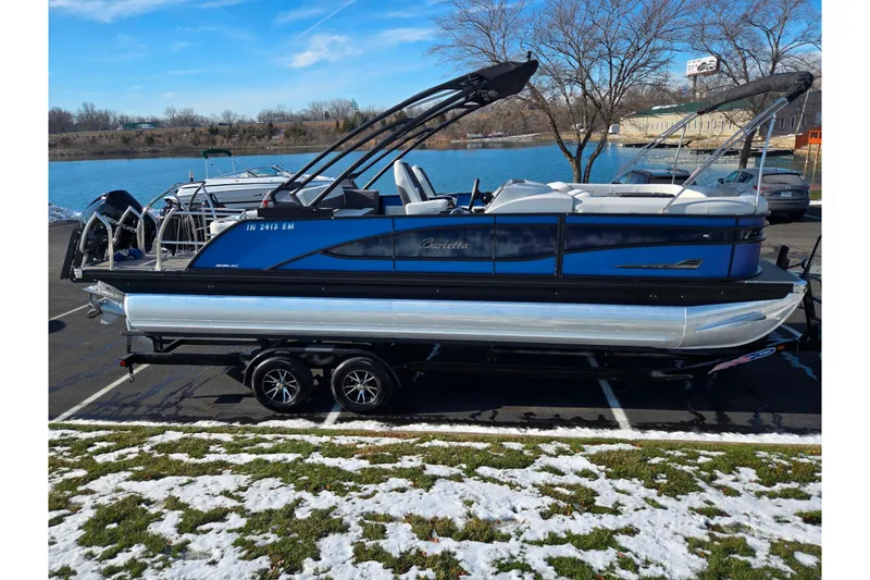 Slide: The Image of 2023 Barletta Corsa 23UC pontoon boat parked near a scenic lake. - 10