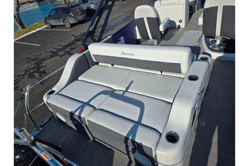Slide: The Image of 2023 Barletta Corsa 23UC boat interior with plush seating and cup holders. - 11
