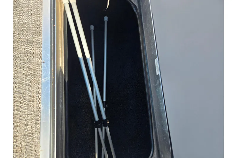 Slide: The Image of Storage compartment of 2023 Barletta Corsa 23UC with metal poles inside. - 17