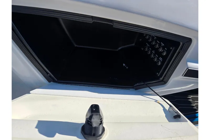 Slide: The Image of 2023 Barletta Corsa 23UC boat dashboard with control panel and storage compartment. - 19