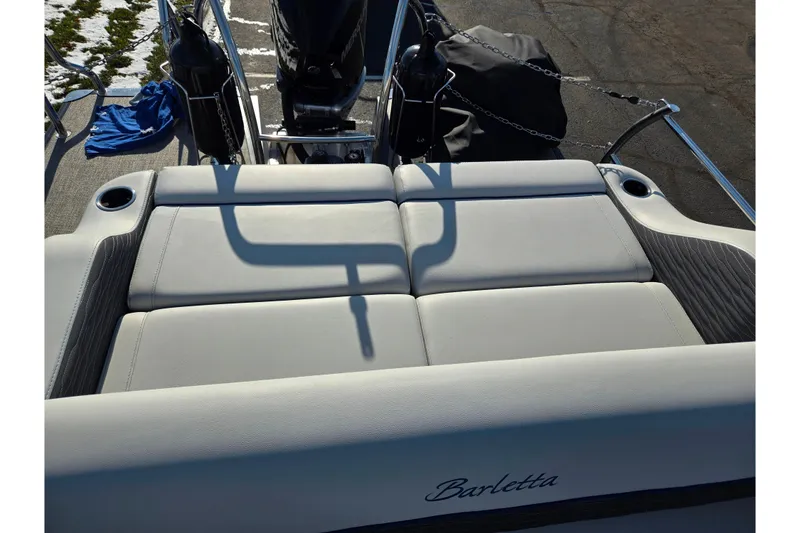 Slide: The Image of 2023 Barletta Corsa 23UC boat interior with cushioned seating and cup holders. - 27