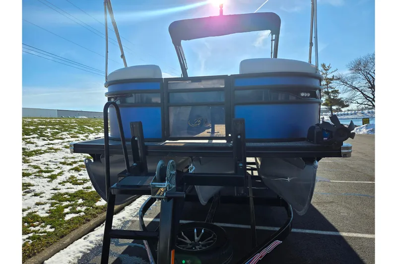 Slide: The Image of 2023 Barletta Corsa 23UC pontoon boat on trailer, sunny day, snowy ground. - 6