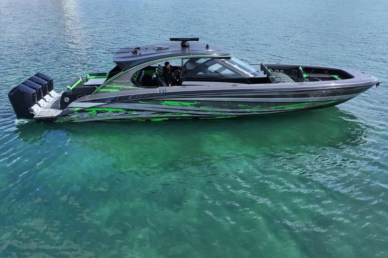 Slide: The Image of 2026 Mystic Powerboats M5200 XL Cabin on clear water, featuring sleek design and vibrant accents. - 1