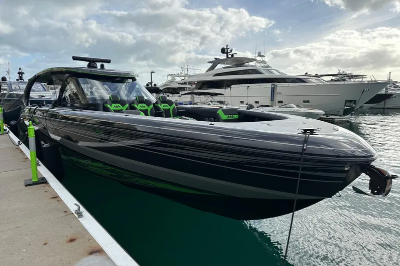 Slide: The Image of 2026 Mystic Powerboats M5200 XL Cabin docked at marina, sleek design, luxury seating. - 12