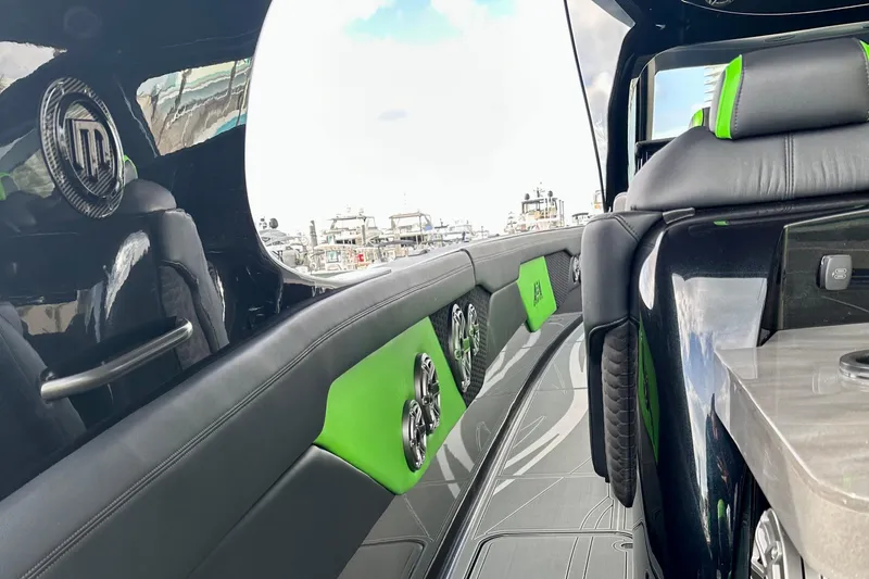 Slide: The Image of Luxurious interior of 2026 Mystic Powerboats M5200 XL Cabin with sleek design and vibrant accents. - 15
