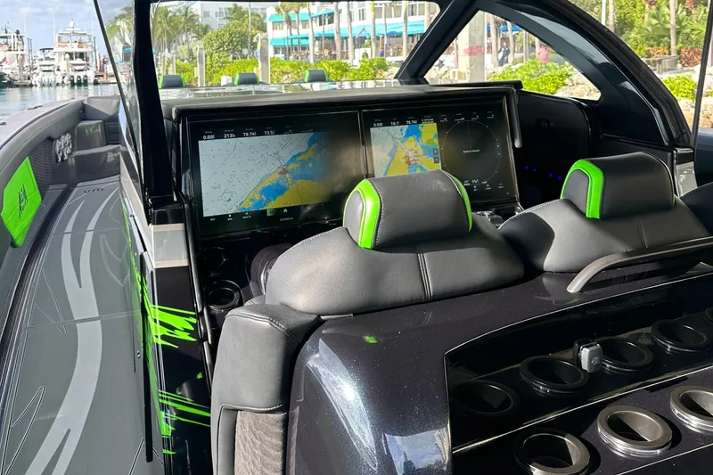 Slide: The Image of 2026 Mystic Powerboats M5200 XL Cabin interior with navigation screens and sleek design. - 16