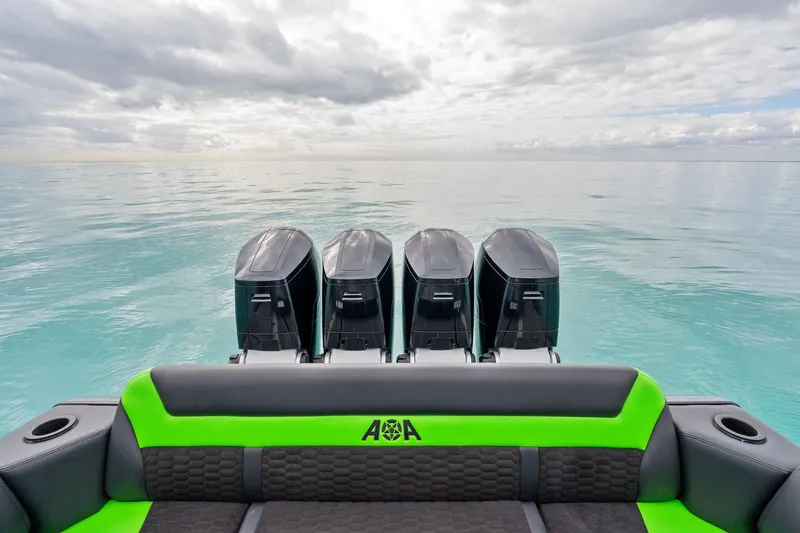 Slide: The Image of 2026 Mystic Powerboats M5200 XL Cabin with four powerful outboard engines on calm sea. - 27