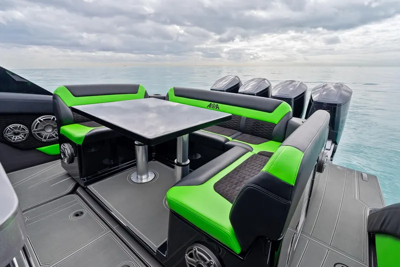 Slide: The Image of 2026 Mystic Powerboats M5200 XL Cabin with sleek seating and modern design on open water. - 28