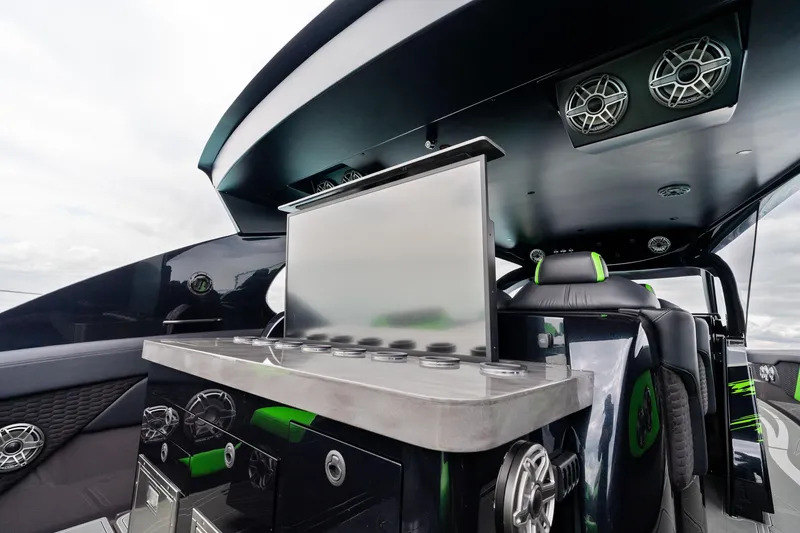 Slide: The Image of 2026 Mystic Powerboats M5200 XL Cabin interior with sleek design and advanced audio system. - 29