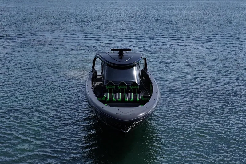 Slide: The Image of 2026 Mystic Powerboats M5200 XL Cabin on serene water under cloudy sky. - 3