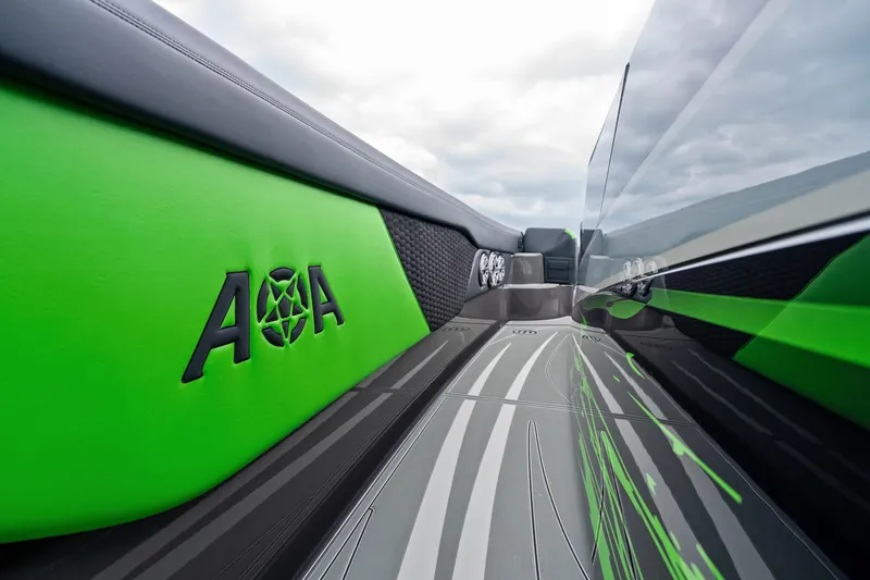 Slide: The Image of 2026 Mystic Powerboats M5200 XL Cabin interior with sleek green and black design. - 30