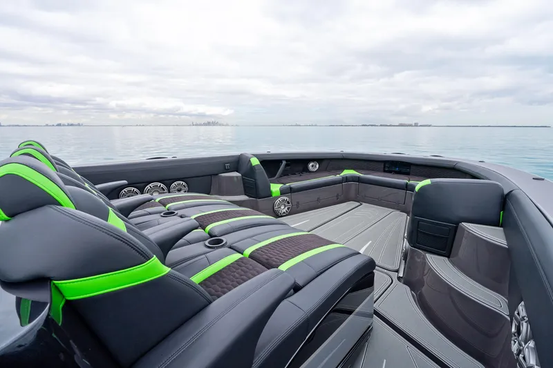 Slide: The Image of 2026 Mystic Powerboats M5200 XL Cabin interior with sleek seating and modern design on open water. - 32