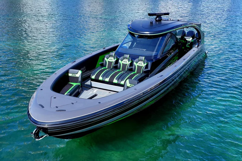 Slide: The Image of 2026 Mystic Powerboats M5200 XL Cabin on clear turquoise water. - 7