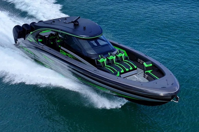Slide: The Image of 2026 Mystic Powerboats M5200 XL Cabin cruising in a busy harbor. - 8