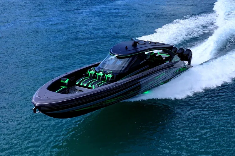 Slide: The Image of 2026 Mystic Powerboats M5200 XL Cabin cruising near a city skyline on a sunny day. - 9